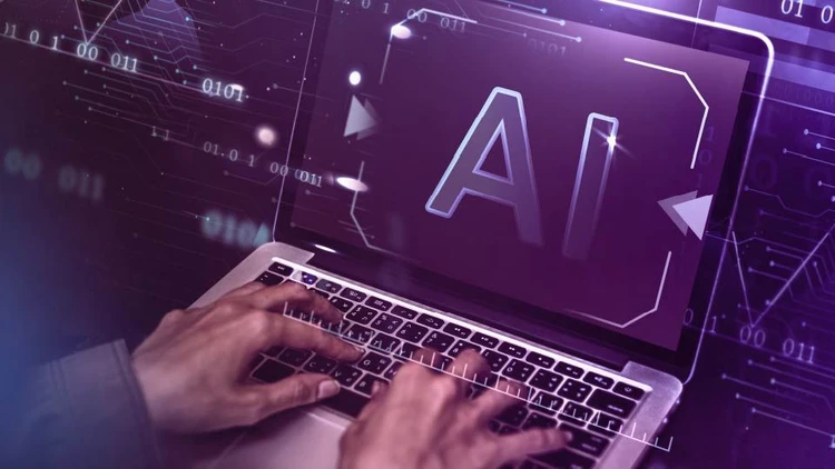 The hands of a person typing on a laptop showing "AI", Artificial Intelligence, symbolizing the development of code and technology.