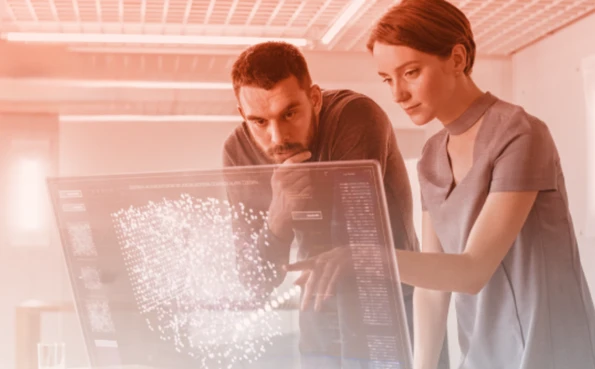 Two professionals analyse complex data on a transparent holographic screen in a modern environment.