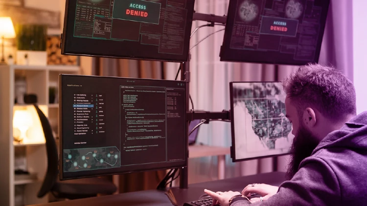 IT operator monitoring threats and access denied alerts, representing the evolution of Autonomous SOCs powered by Artificial Intelligence.