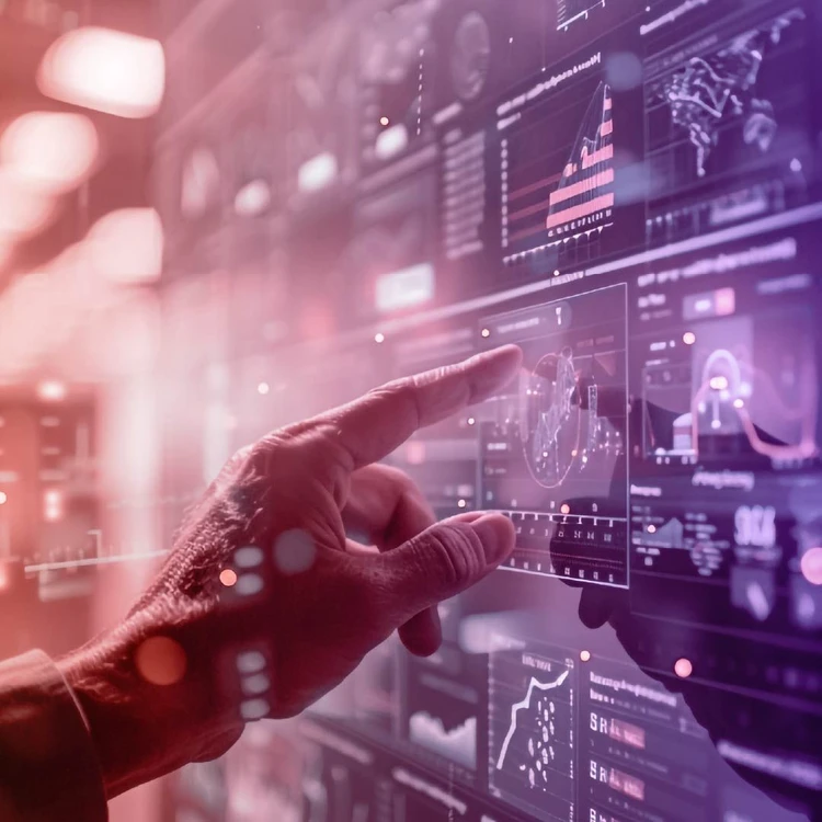 A hand points to and touches digital data on a large transparent screen, displaying graphs and diagrams.
